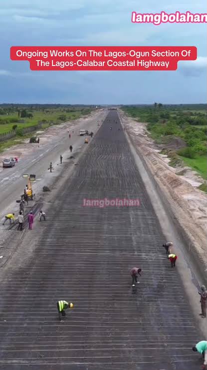 Aerial view of roadworks in progress on the Coastal Highway, with crews and machinery laying the sub-base across open ground.